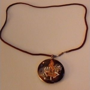 Woman on horse pendant necklace color is brown